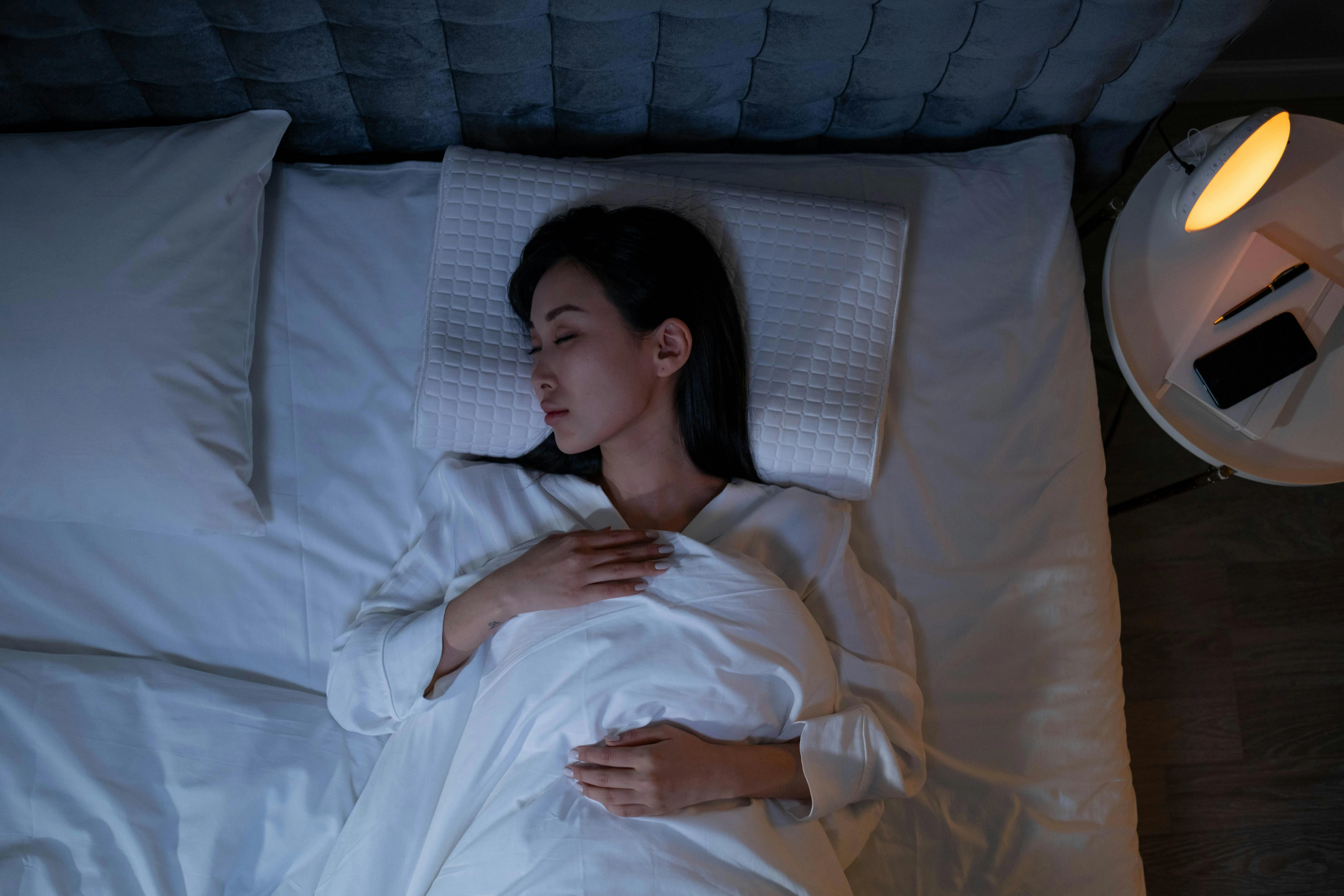 person sleeping comfortably in a dark room