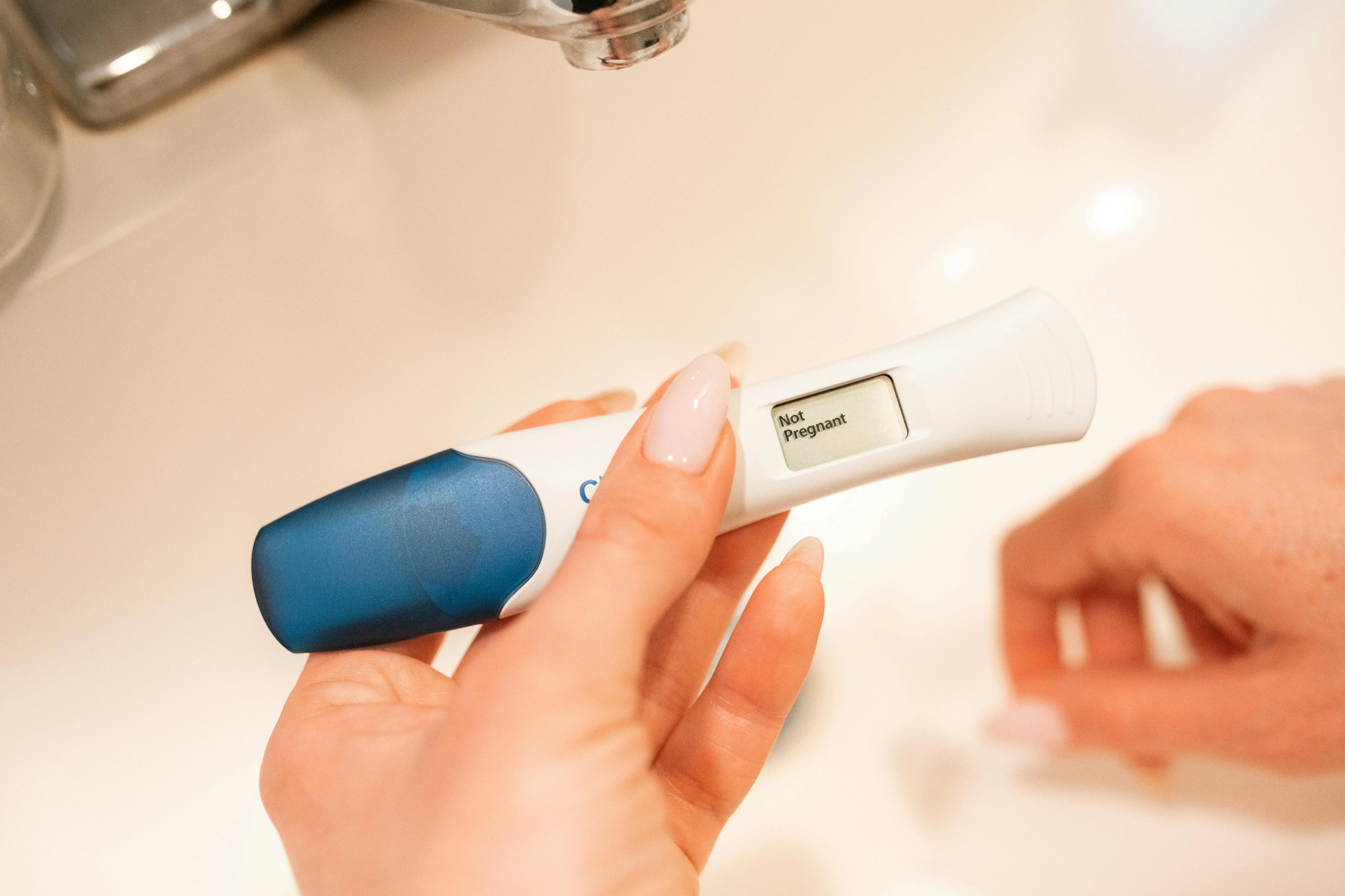 photo of person holding negative pregnancy test